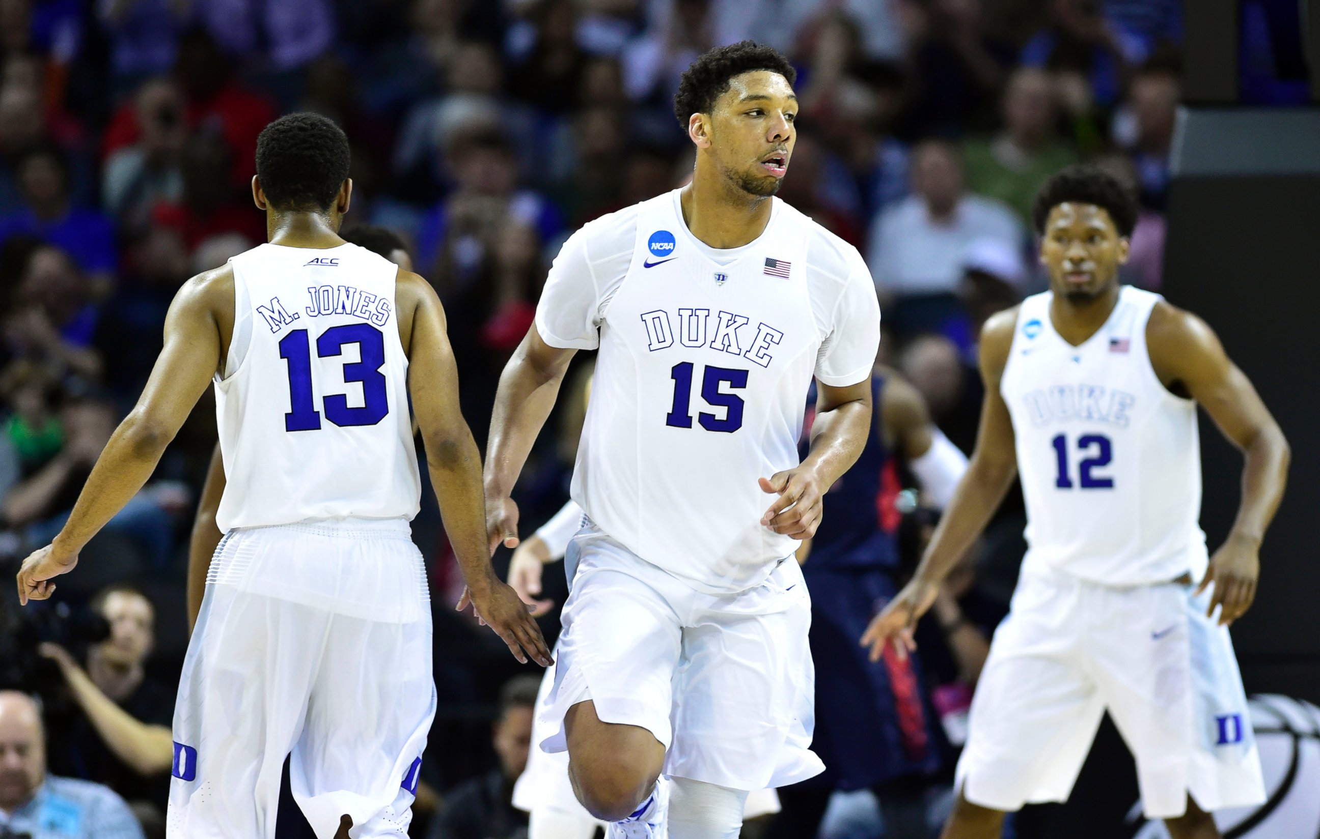 PHOTO: Duke Blue Devils center Jahlil Okafor (15) celebrates with Duke Blue Devils guard Matt Jones (13) after a dunk against the Robert Morris Colonials during the 2015 NCAA Tournament in Charlotte, N.C., March 20, 2015.