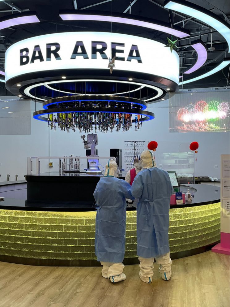 PHOTO: Health officials at the Beijing Olympics test the bar area for COVID-19, ahead of the 2022 Winter Games.