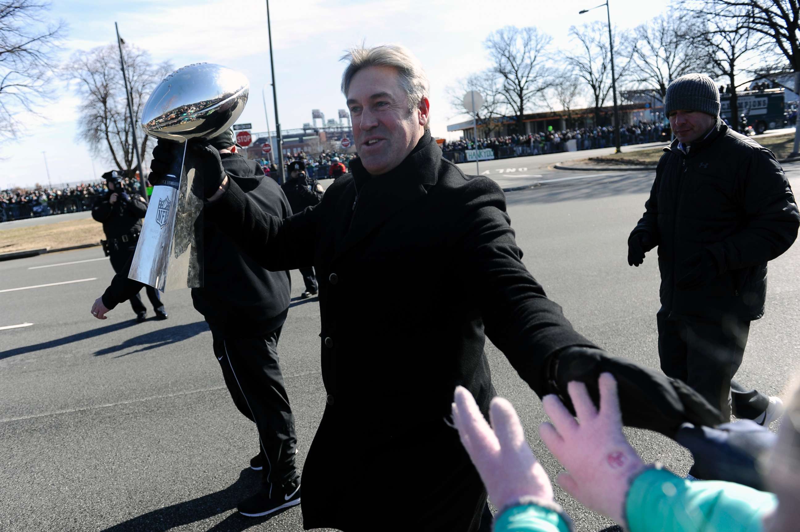 PHOTO: Philadelphia Eagles head coach Doug Pederson walks along the parade route with the Lombardi Trophy during the Super Bowl LII victory parade, Feb 8, 2018, in Philadelphia.
