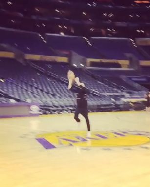 Justin Timberlake did his best Steph Curry impression by launching a half-court shot on the Lakers court - and nailing it.