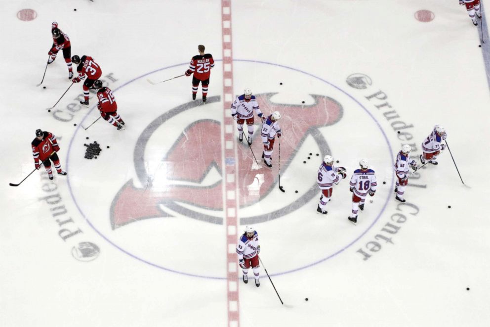 PHOTO: In this April 1, 2019, file photo, New Jersey Devils, left, and New York Rangers warm up for an NHL hockey game in Newark, N.J.