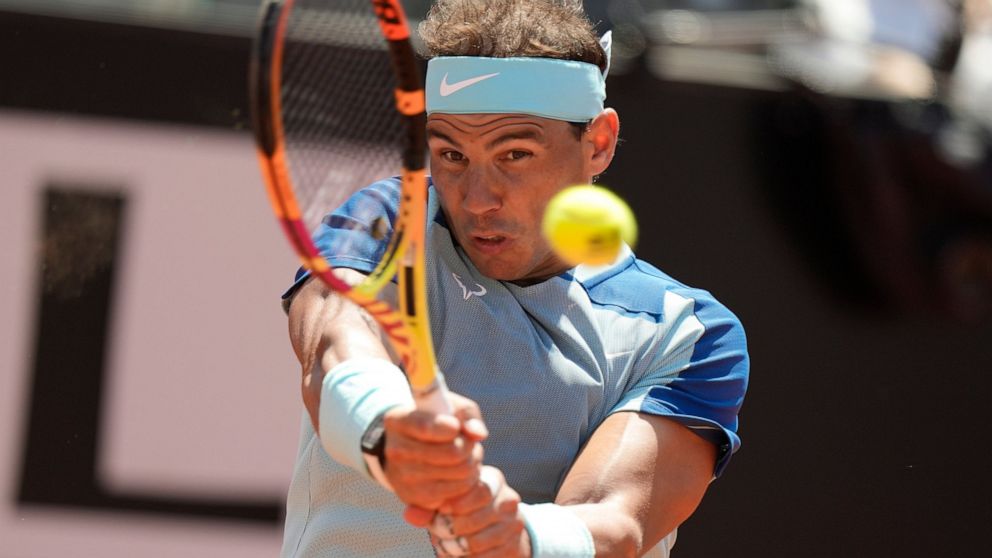 Rafael Nadal returns the ball to John Isner during their match at the Italian Open tennis tournament, in Rome, Wednesday, May 11, 2022. (AP Photo/Andrew Medichini)