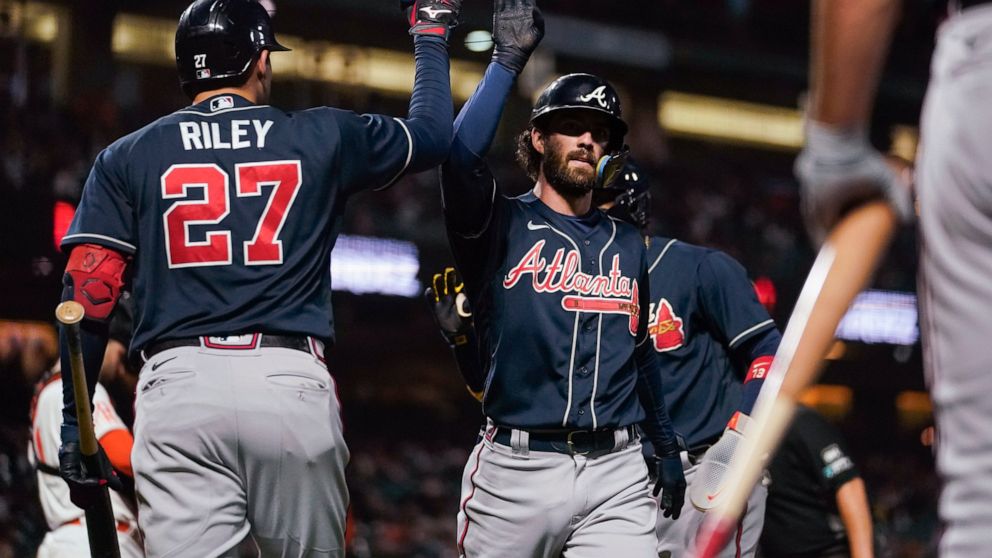 Atlanta Braves' Dansby Swanson celebrates with Austin Riley, left, after hitting a two-run home run against the San Francisco Giants during the third inning of a baseball game in San Francisco, Tuesday, Sept. 13, 2022. (AP Photo/Godofredo A. Vásquez)