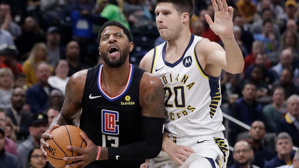 Los Angeles Clippers' Paul George (13) goes to the basket against Indiana Pacers' Doug McDermott (20) during the first half of an NBA basketball game, Monday, Dec. 9, 2019, in Indianapolis. (AP Photo/Darron Cummings)