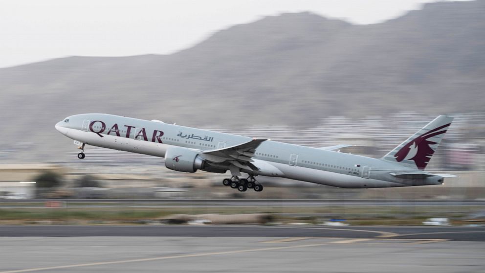FILE - A Qatar Airways aircraft takes off with foreigners from the airport in Kabul, Afghanistan, on Sept. 9, 2021. World Cup host nation Qatar, said Monday, Nov. 14, 2022, that it will count emissions produced from daily flights ferrying fans during