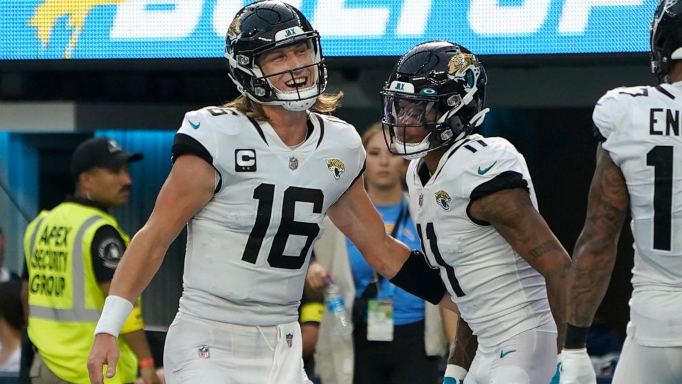 Jacksonville Jaguars quarterback Trevor Lawrence (16) and wide receiver Marvin Jones Jr. celebrate after connecting on a touchdown pass during the second half of an NFL football game against the Los Angeles Chargers in Inglewood, Calif., Sunday, Sept