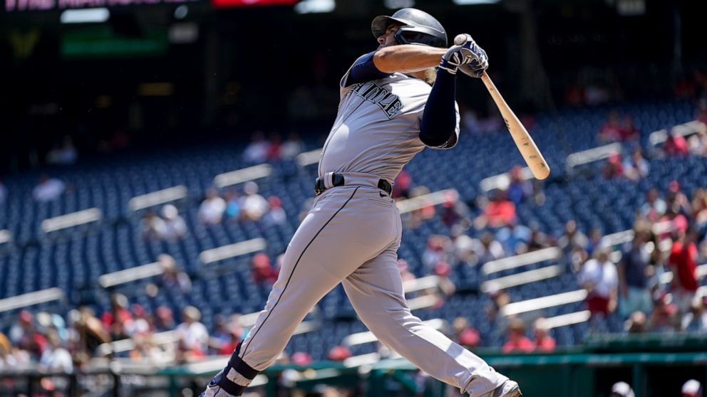 Seattle Mariners' Eugenio Suarez hits a three-run home run in the first inning of the first game of a baseball doubleheader against the Washington Nationals, Wednesday, July 13, 2022, in Washington. (AP Photo/Patrick Semansky)