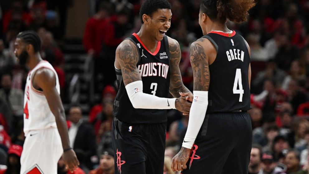 Houston Rockets guard Kevin Porter Jr. (3) celebrates with guard Jalen Green (4) after making a 3-point basket against the Chicago Bulls during the second half of an NBA basketball game Monday, Dec. 26, 2022, in Chicago. (AP Photo/Quinn Harris)