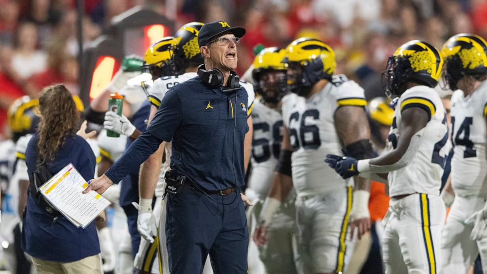 Michigan coach Jim Harbaugh yells to officials during a timeout in the first half of an NCAA college football game against Nebraska on Saturday, Oct. 9, 2021, in Lincoln, Neb. (AP Photo/Rebecca S. Gratz)