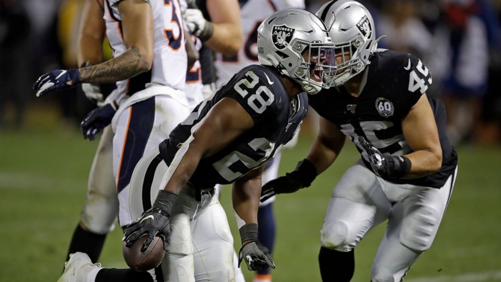 Oakland Raiders running back Josh Jacobs (28) celebrates after scoring a touchdown during the fourth quarter of an NFL football game against the Denver Broncos Monday, Sept. 9, 2019, in Oakland, Calif. At right is running back Alec Ingold (45). (AP P