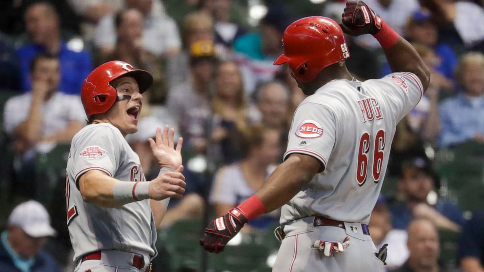 Cincinnati Reds' Derek Dietrich congratulates Yasiel Puig after his two-run home run during the eighth inning of a baseball game against the Milwaukee Brewers Friday, June 21, 2019, in Milwaukee. (AP Photo/Morry Gash)