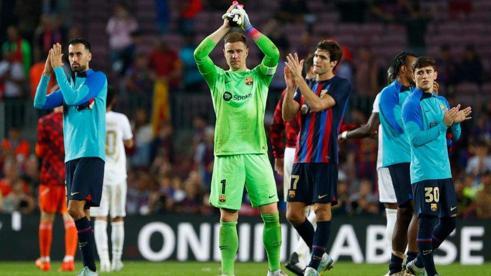 Barcelona's Sergio Busquets, left, and Barcelona's goalkeeper Marc-Andre ter Stegen applauds fans at the end of the Champions League Group C soccer match between Barcelona and Bayern Munich at the Camp Nou stadium in Barcelona, Spain, Wednesday, Oct.