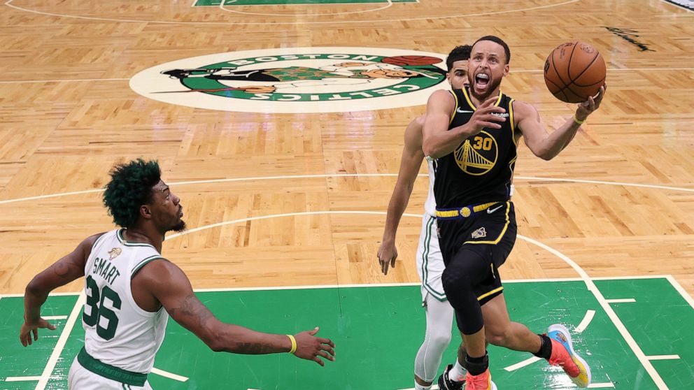 Golden State Warriors guard Stephen Curry (30) goes up for a shot against the Boston Celtics during Game 3 of basketball's NBA Finals, Wednesday, June 8, 2022, in Boston. (Elsa/Pool Photo via AP)