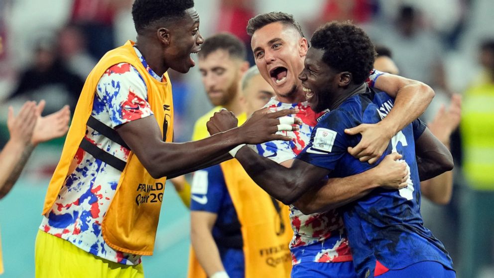 United States' Yunus Musah, right, Aaron Long, center, and United States' goalkeeper Sean Johnson celebrate after defeating Iran in the World Cup group B soccer match between Iran and the United States at the Al Thumama Stadium in Doha, Qatar, Tuesda