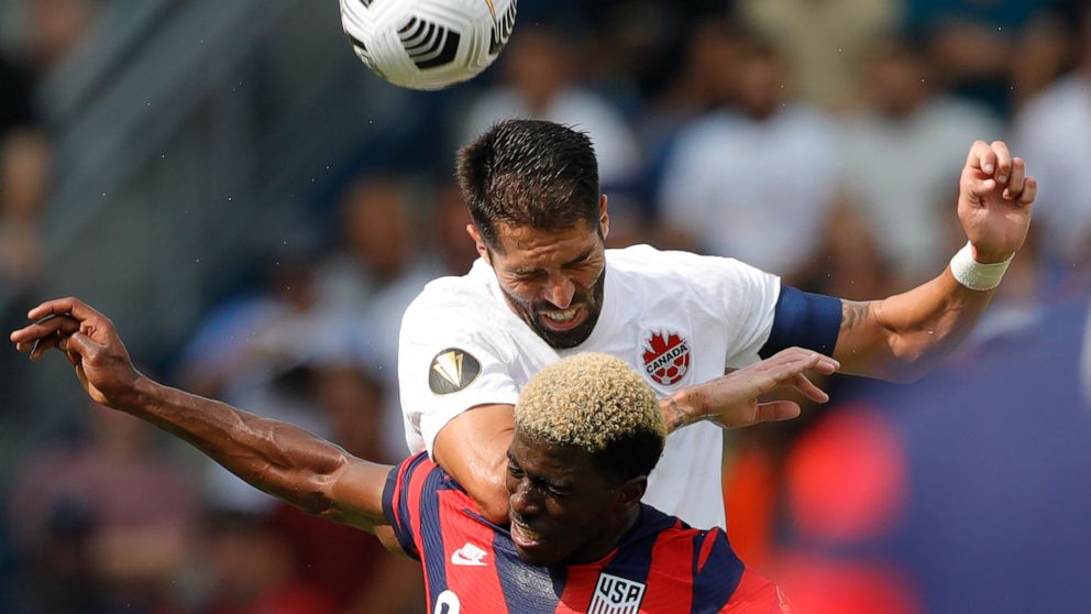 United States forward Gyasi Zardes (9) and Canada defender Steven Vitoria (5) go up for the ball during the first half of a CONCACAF Gold Cup soccer match in Kansas City, Kan., Sunday, July 18, 2021. (AP Photo/Colin E. Braley)