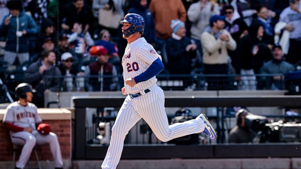 New York Mets designated hitter Pete Alonso (20) scores off of an RBI double from New York Mets' Eduardo Escobar against the Arizona Diamondbacks during the bottom of the sixth inning of a baseball game, Sunday, April 17, 2022 in New York. (AP Photo/