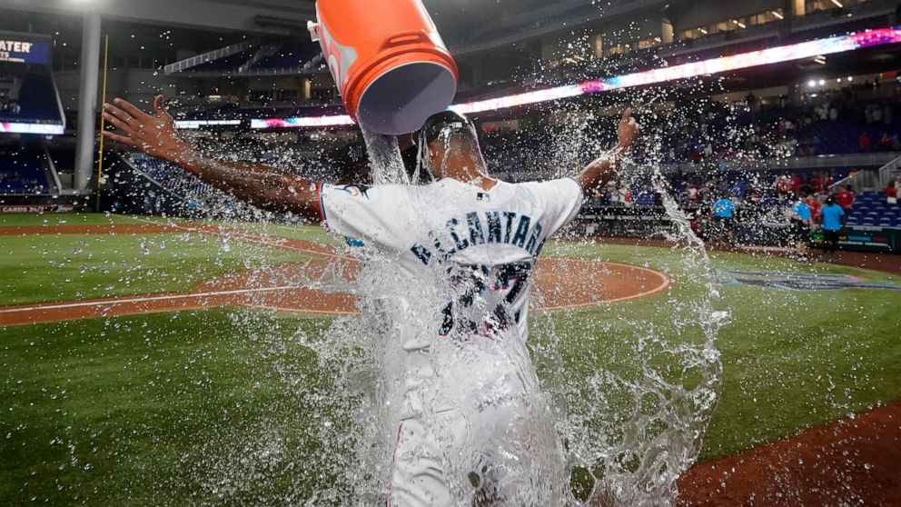 Miami Marlins starting pitcher Sandy Alcantara is doused by Pablo Lopez after the Marlins beat the Cincinnati Reds 3-0 in a baseball game, Wednesday, Aug. 3, 2022, in Miami. (AP Photo/Wilfredo Lee)