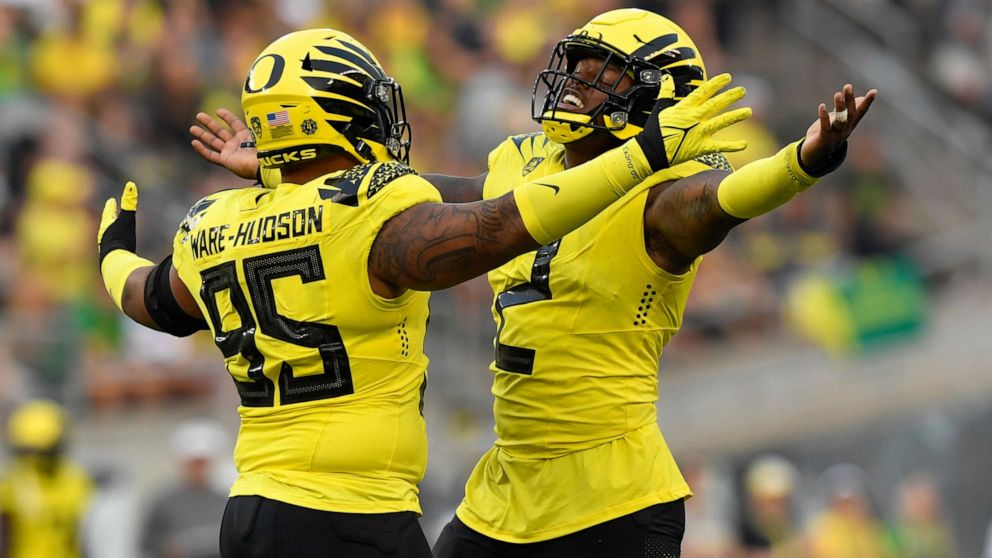 Oregon defensive tackle Keyon Ware-Hudson (95) and linebacker DJ Johnson (2) celebrate a sack against Eastern Washington during the second quarter of an NCAA college football game Saturday, Sept. 10, 2022, in Eugene, Ore. (AP Photo/Andy Nelson)