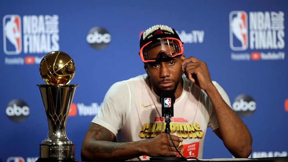 Toronto Raptors forward Kawhi Leonard speaks at a news conference alongside the NBA Finals Most Valuable Player trophy after the Raptors defeated the Golden State Warriors in Game 6 of basketball's NBA Finals in Oakland, Calif., Thursday, June 13, 20