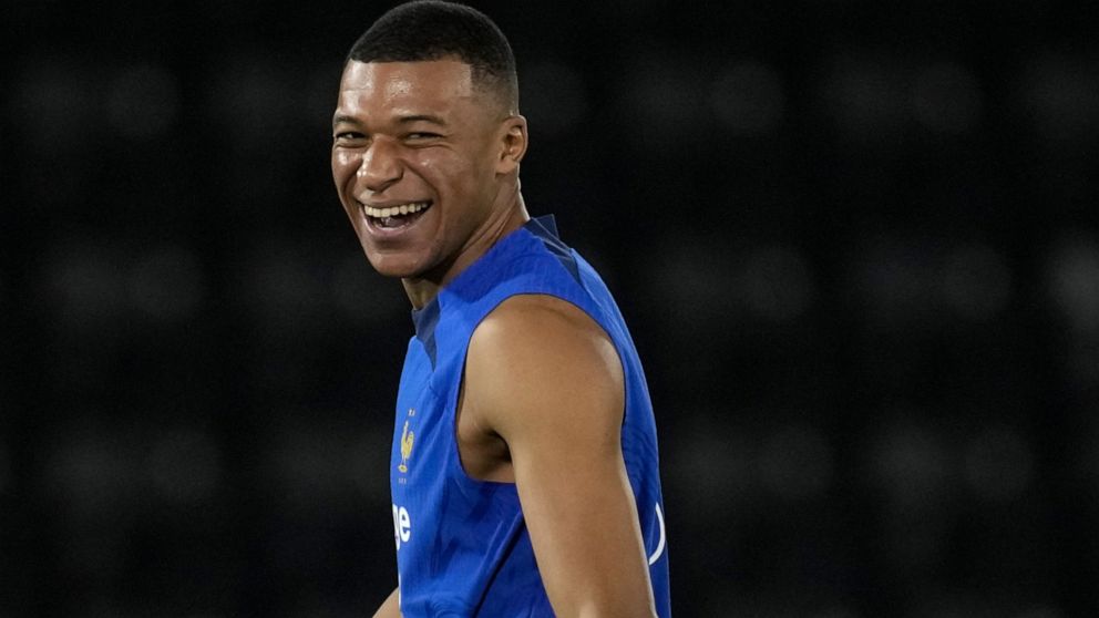 France's Kylian Mbappe, jokes with teammates during a training session at the Jassim Bin Hamad stadium in Doha, Qatar, Monday, Nov. 28, 2022. France will play in the World Cup against Tunisia on Nov. 30. (AP Photo/Christophe Ena)