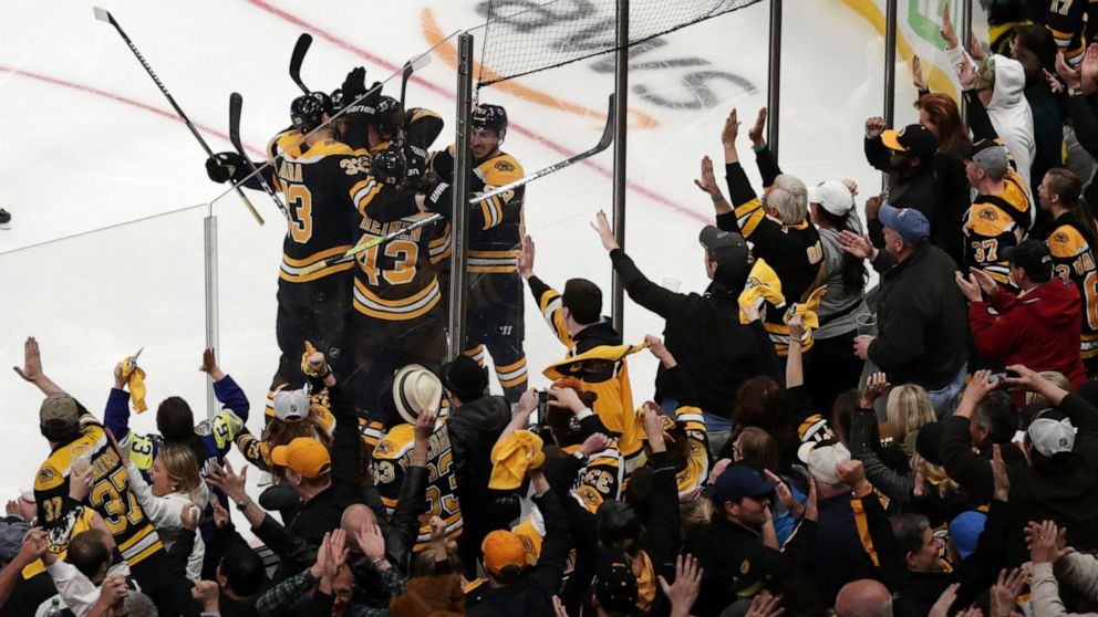 Boston Bruins fans celebrate after a goal by Bruins center Sean Kuraly (52) against the Toronto Maple Leafs during the third period of Game 7 of an NHL hockey first-round playoff series, Tuesday, April 23, 2019, in Boston. (AP Photo/Charles Krupa)