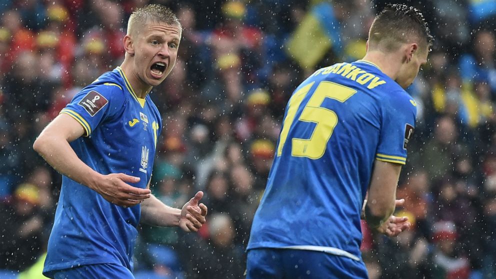 Ukraine's Oleksandr Zinchenko, left, and Ukraine's Viktor Tsygankov during the World Cup 2022 qualifying play-off soccer match between Wales and Ukraine at Cardiff City Stadium, in Cardiff, Wales, Sunday, June 5, 2022. (AP Photo/Rui Vieira)