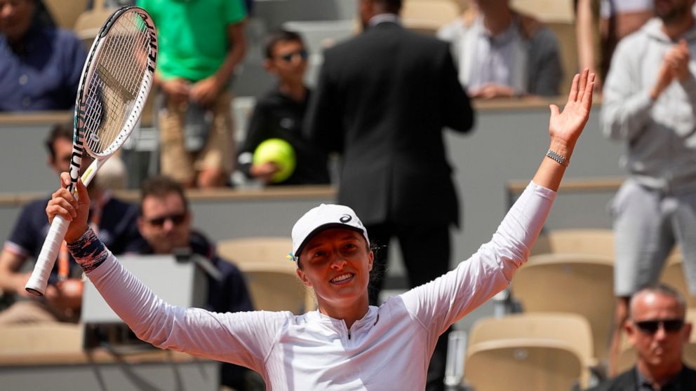 Poland's Iga Swiatek celebrates winning her third round match Montenegro's Danka Kovinic in two sets, 6-3, 7-5, at the French Open tennis tournament in Roland Garros stadium in Paris, France, Saturday, May 28, 2022. (AP Photo/Michel Euler)