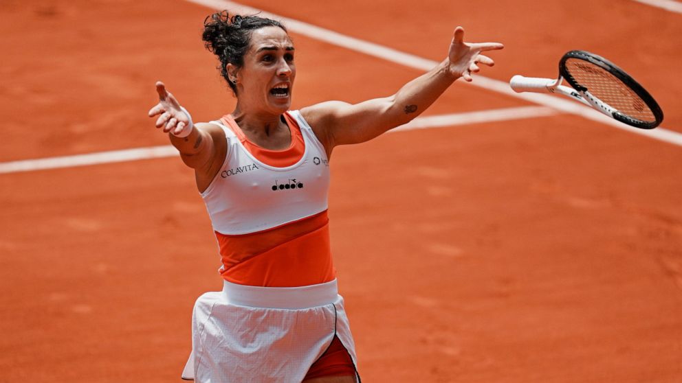 Italy's Martina Trevisan celebrates winning her quarterfinal match against Canada's Leylah Fernandez in three sets, 6-2, 6-7 (3-7), 6-3, at the French Open tennis tournament in Roland Garros stadium in Paris, France, Tuesday, May 31, 2022. (AP Photo/