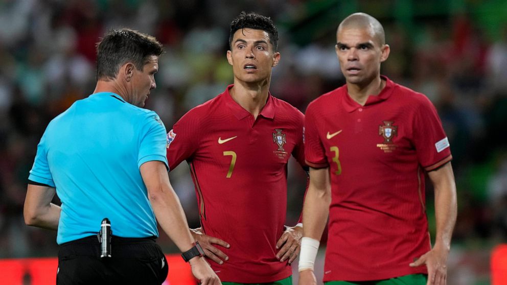 Portugal's Cristiano Ronaldo and his teammate Pepe look to the referee Matej Jug during the UEFA Nations League soccer match between Portugal and the Czech Republic, at the Jose Alvalade Stadium in Lisbon, Thursday, June 9, 2022. (AP Photo/Armando Franca)