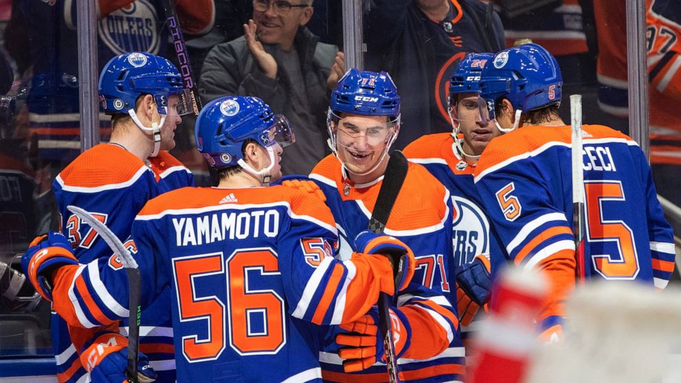 Edmonton Oilers' Ryan McLeod (71) celebrates with teammates after his goal against the Calgary Flames during the second period of an NHL hockey game Saturday, Oct. 15, 2022, in Edmonton, Alberta. (Jason Franson/The Canadian Press via AP)