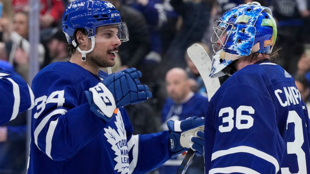 Toronto Maple Leafs center Auston Matthews (34) and goaltender Jack Campbell (36) celebrate the team's 7-3 win over the Washington Capitals in an NHL hockey game Thursday, April 14, 2022, in Toronto. (Frank Gunn/The Canadian Press via AP)