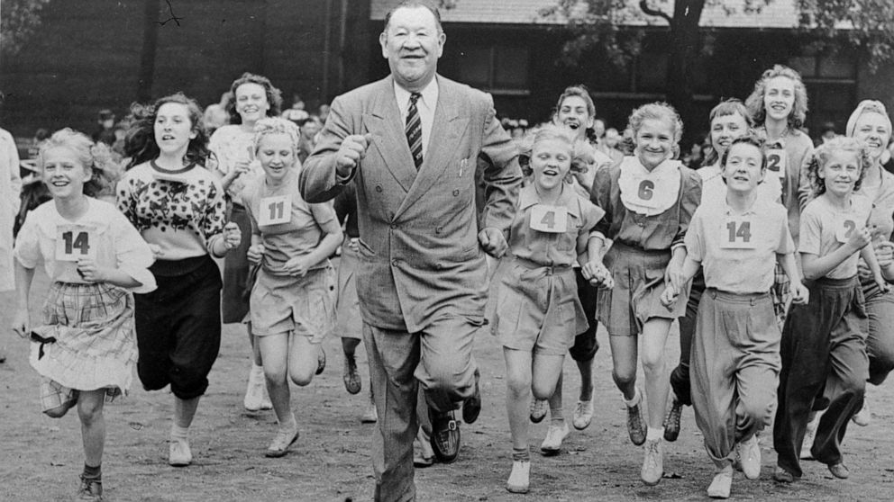 FILE - Big Jim Thorpe, famed American athlete and former U.S. Olympic great, center, sets a fast pace for some girls during a "junior olympics" event on Chicago's south side June 6, 1948 sponsored by a V.F.W. post. Jim Thorpe has been reinstated as t