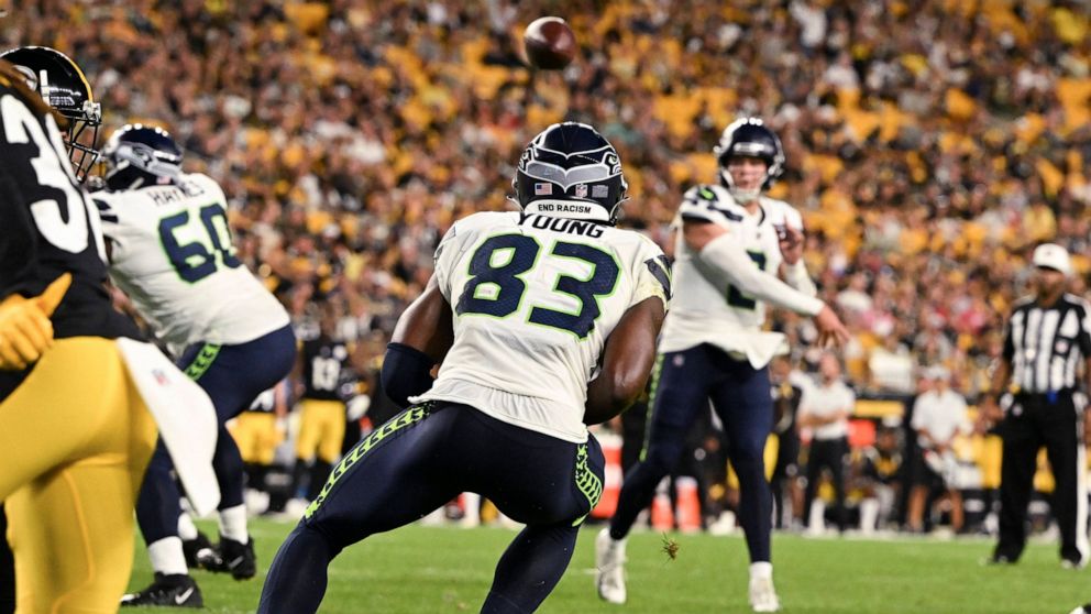 Seattle Seahawks quarterback Drew Lock, rear, throws a touchdown pass to wide receiver Dareke Young (83) against the Pittsburgh Steelers during the second half of an NFL preseason football game Saturday, Aug. 13, 2022, in Pittsburgh. (AP Photo/Barry 