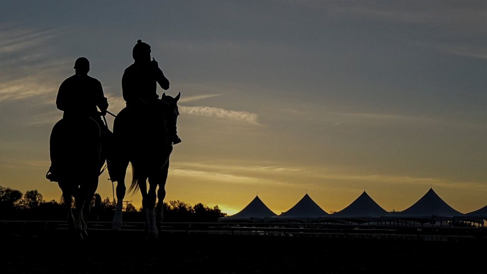 Horse trainer D. Wayne Lukas, left, rides atop Riff as he helps exercise rider Oscar Quevedo and Preakness entrant Secret Oath onto the track for a morning workout ahead of the Preakness Horse Race at Pimlico Race Course, Wednesday, May 18, 2022, in 