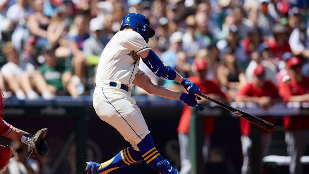 Seattle Mariners' Jesse Winker hits a grand slam against the Los Angeles Angels on a pitch from Tucker Davidson during third inning of a baseball game, Sunday, Aug. 7, 2022, in Seattle. (AP Photo/John Froschauer)