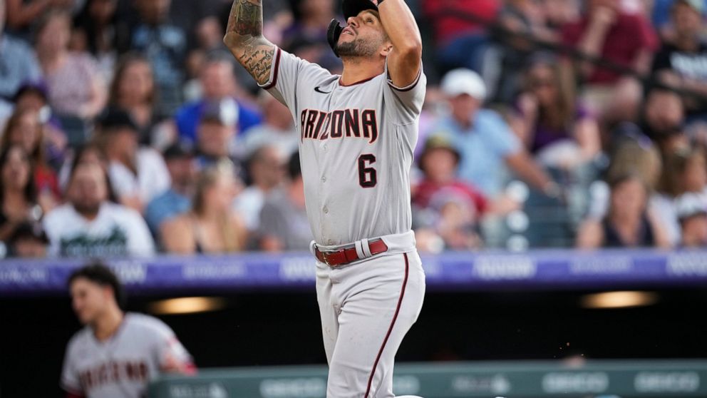 Arizona Diamondbacks' David Peralta gestures as he crosses home plate after hitting a solo home run off Colorado Rockies relief pitcher Ty Blach during the sixth inning of a baseball game Friday, July 1, 2022, in Denver. (AP Photo/David Zalubowski)