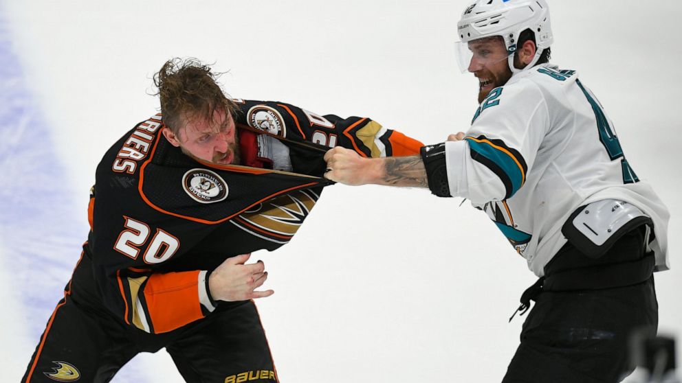 Anaheim Ducks left wing Nicolas Deslauriers (20) and San Jose Sharks left wing Jonah Gadjovich (42) fight during the first period in an NHL hockey game Tuesday, Feb. 22, 2022, in Anaheim, Calif. (AP Photo/John McCoy)