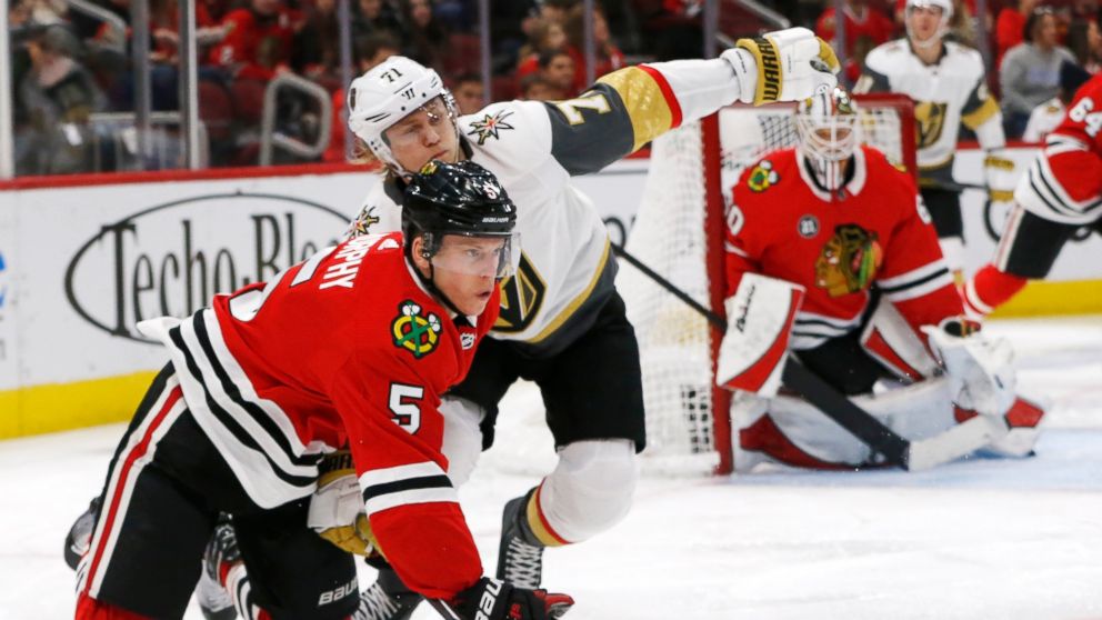Chicago Blackhawks defenseman Connor Murphy (5) gets the puck away from Vegas Golden Knights center William Karlsson (71) during the second period of an NHL hockey game Saturday, Jan. 12, 2019, in Chicago. (AP Photo Nuccio DiNuzzo)