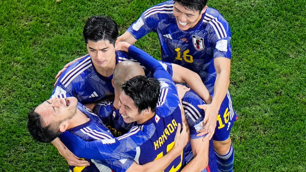 Japan's Daizen Maeda celebrates with his teammates after scoring his side's opening goal during the World Cup round of 16 soccer match between Japan and Croatia at the Al Janoub Stadium in Al Wakrah, Qatar, Monday, Dec. 5, 2022. (AP Photo/Hassan Ammar)