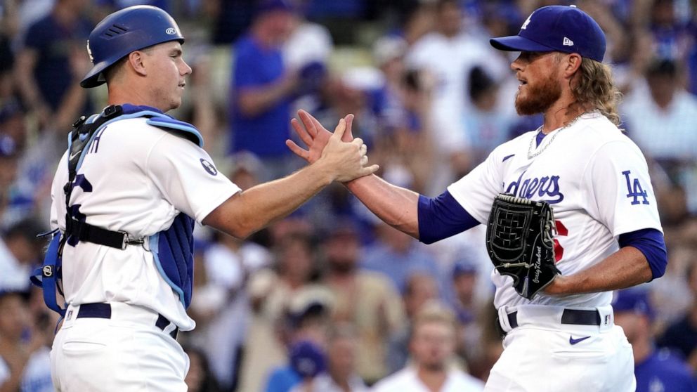 Los Angeles Dodgers catcher Will Smith, left, and relief pitcher Craig Kimbrel congratulate each other after the Dodgers defeated the San Diego Padres 4-0 in a baseball game Sunday, Aug. 7, 2022, in Los Angeles. (AP Photo/Mark J. Terrill)