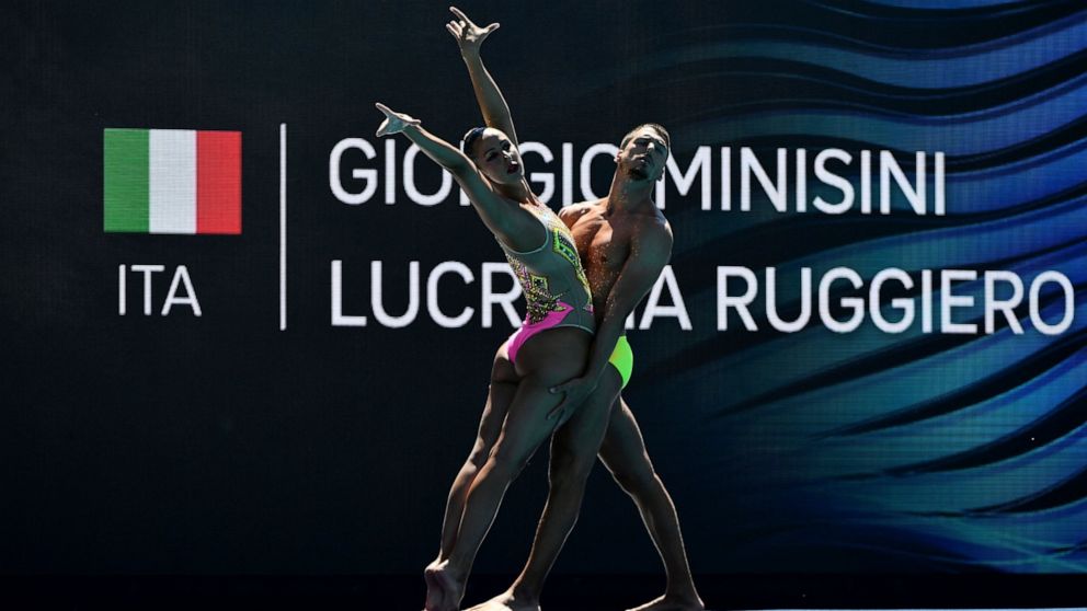 FILE - Italy's Giorgio Minisi and Lucrezia Ruggiero compete during the mixed duet technical final of the artistic swimming at the 19th FINA World Championships in Budapest, Hungary, on June 20, 2022. Men can compete in Olympic artistic swimming for t