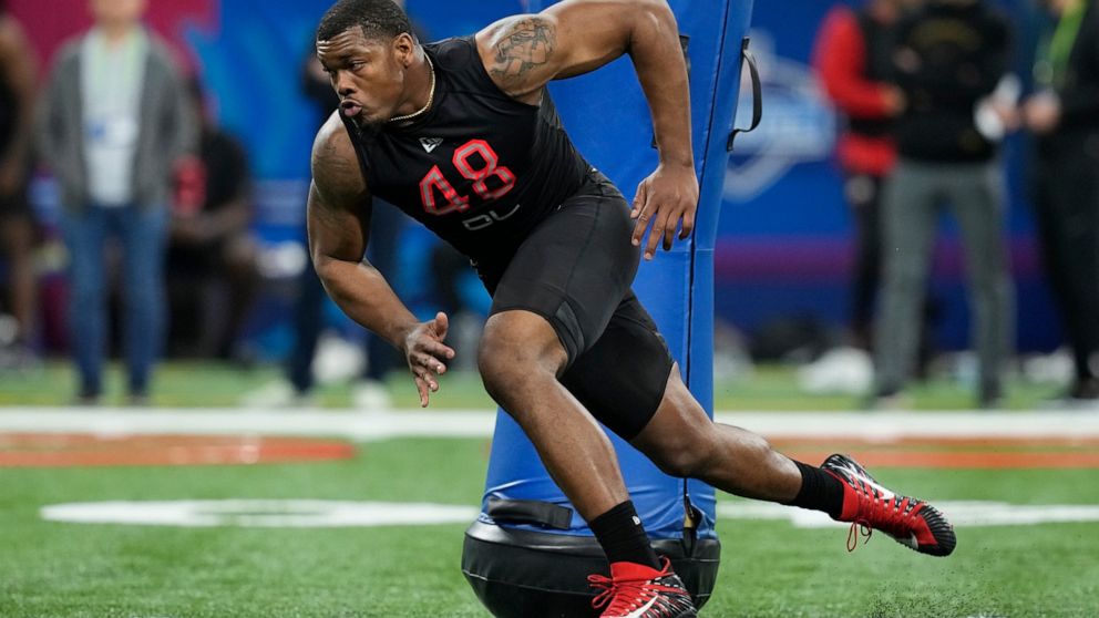 FILE - Georgia defensive lineman Travon Walker runs a drill during the NFL football scouting combine, Saturday, March 5, 2022, in Indianapolis. Walker is expected to be taken in the NFL Draft. (AP Photo/Darron Cummings, File)