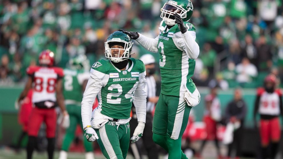 Saskatchewan Roughriders defensive back Damon Webb (24) and teammate Nick Marshall (3) celebrate after a referee makes a call in their favor during the first half of a CFL football game against the Calgary Stampeders Sunday, Nov. 28., 2021 in Regina,