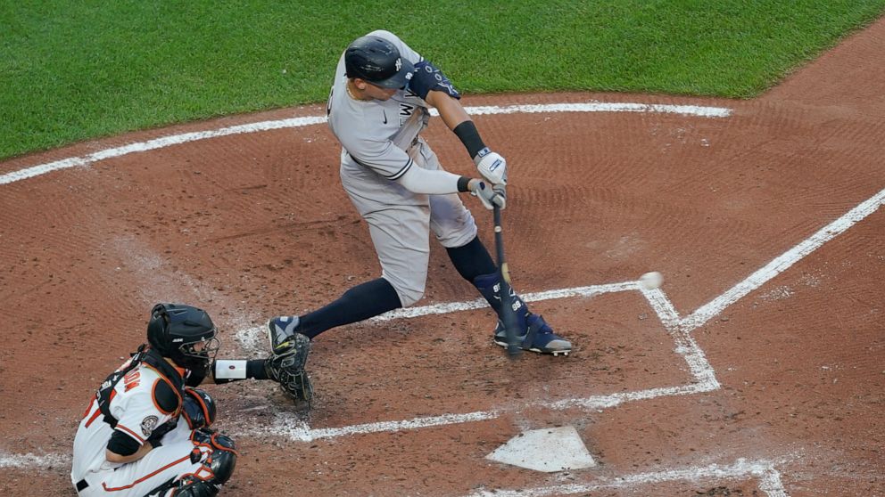 New York Yankees' Aaron Judge connects for a solo home run off Baltimore Orioles starting pitcher Spenser Watkins during the third inning of a baseball game, Tuesday, May 17, 2022, in Baltimore. (AP Photo/Julio Cortez)