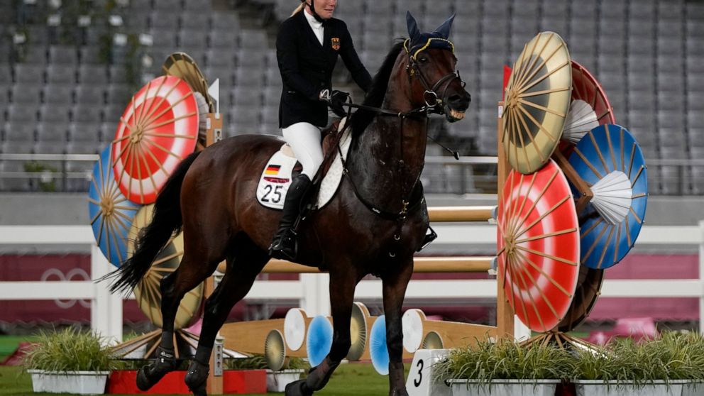FILE - Annika Schleu of Germany cries after she couldn't control her horse to compete in the equestrian portion of the women's modern pentathlon at the 2020 Summer Olympics, in Tokyo, Japan, on Aug. 6, 2021. Amid a bitter divide with Olympic athletes