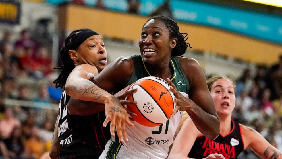 Seattle Storm center Tina Charles (31) gets tied up by Indiana Fever forward Emma Cannon (32) in the first half of a WNBA basketball game in Indianapolis, Tuesday, July 5, 2022. (AP Photo/Michael Conroy)