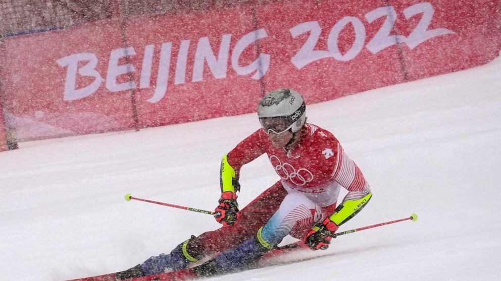 Marco Odermatt, of Switzerland approaches a gate during the first run of the men's giant slalom at the 2022 Winter Olympics, Sunday, Feb. 13, 2022, in the Yanqing district of Beijing. (AP Photo/Robert F. Bukaty)