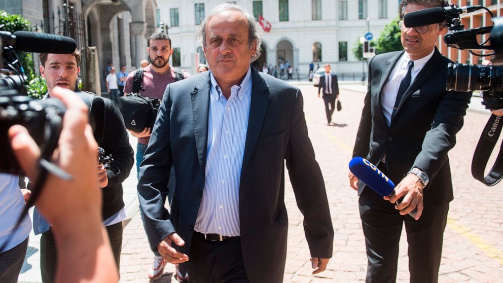 The former president of the the European Football Association (Uefa) Michel Platini, center, is leaving the Swiss Federal Criminal Court in Bellinzona, Switzerland, after the first day of his trial, Wednesday, June 8, 2022. Platini and the former pre