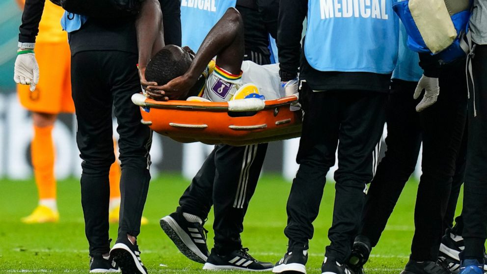 Senegal's Cheikhou Kouyate is taken from the field on a stretcher during the World Cup, group A soccer match between Senegal and Netherlands at the Al Thumama Stadium in Doha, Qatar, Monday, Nov. 21, 2022. (AP Photo/Petr David Josek)