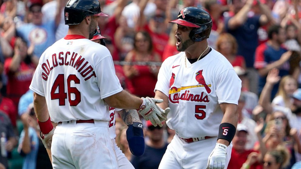 St. Louis Cardinals' Albert Pujols (5) is congratulated by teammate Paul Goldschmidt (46) after hitting a three-run home run during the eighth inning of a baseball game against the Milwaukee Brewers Sunday, Aug. 14, 2022, in St. Louis. (AP Photo/Jeff